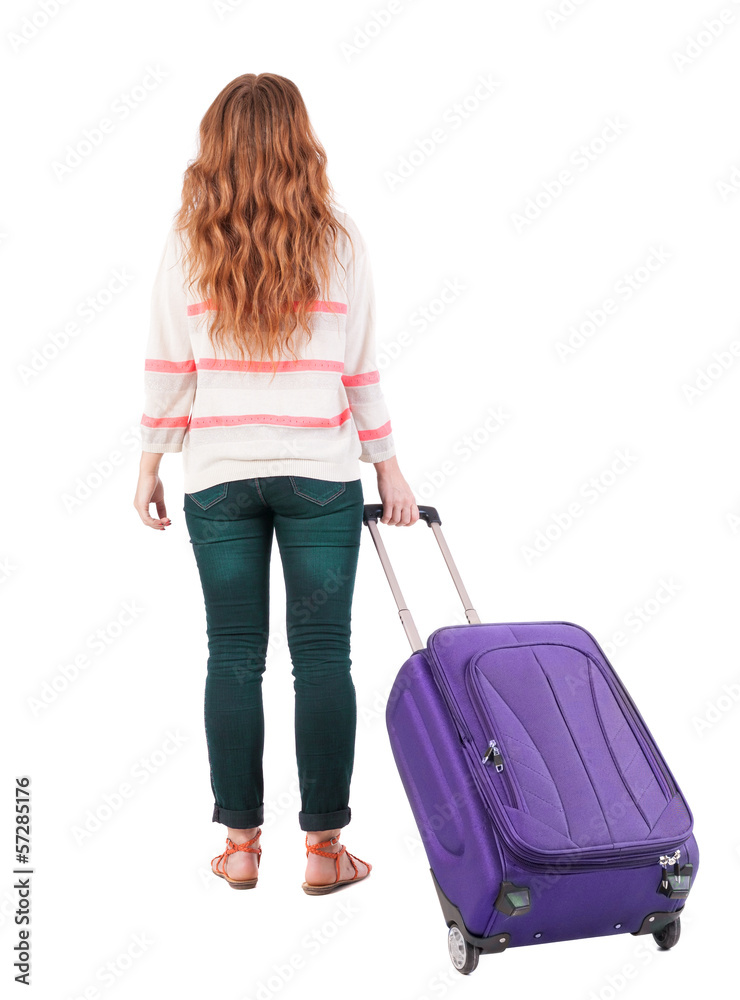 back view of walking woman with suitcase. back view of walking woman with suitcase.