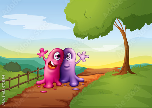 Two monsters walking at the pathway in the hilltop