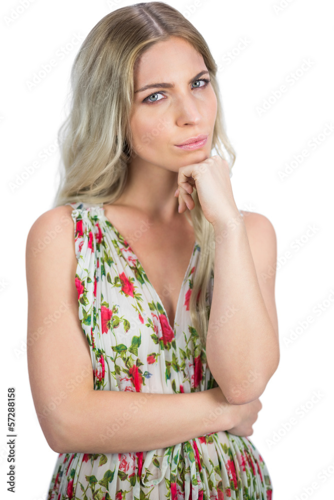 Thoughtful pretty blonde wearing flowered dress posing Thoughtful pretty blonde wearing flowered dress posing