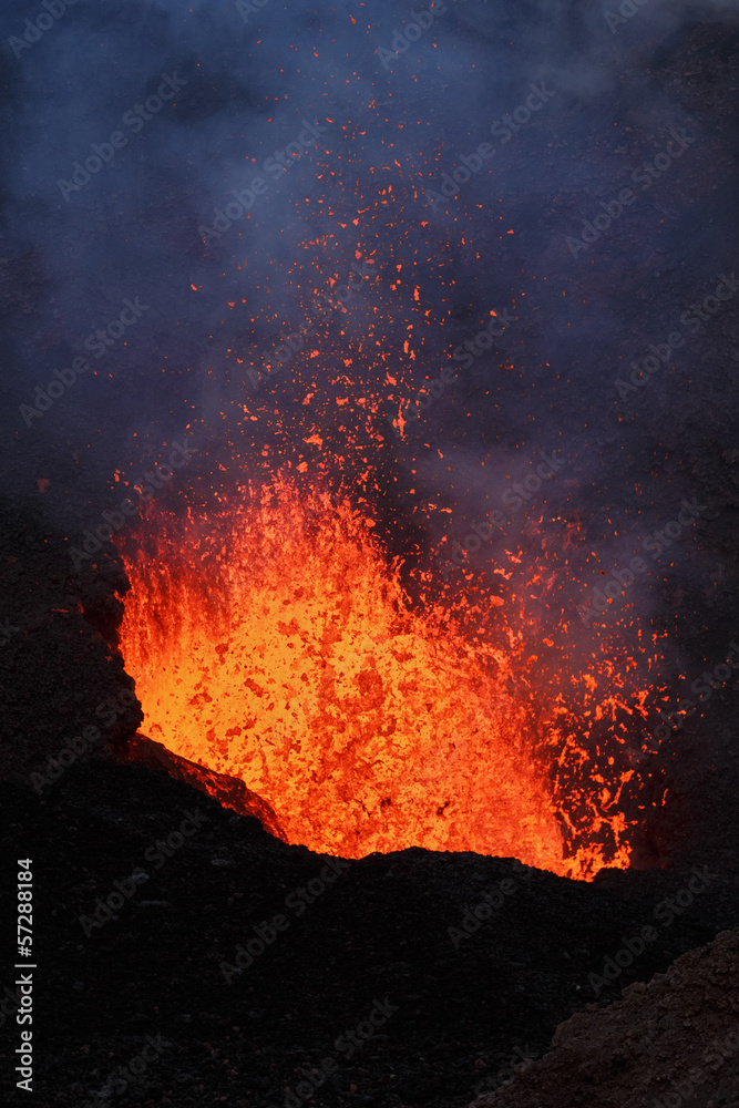 Volcanic landscape of Kamchatka Peninsula: night eruption active Tolbachik Volcano - lava lake, lava flowing in crater of volcano. Russian Far East, Kamchatka Region, Klyuchevskaya Group of Volcanoes.