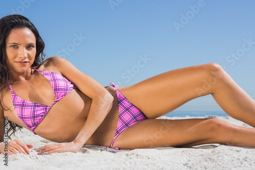 Attractive young woman in pink bikini enjoying sun