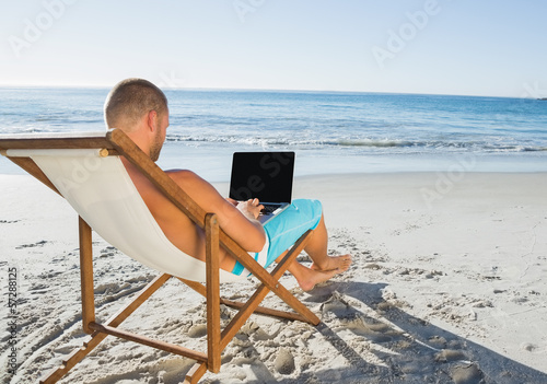 Relaxed handsome man working on his laptop © WavebreakmediaMicro