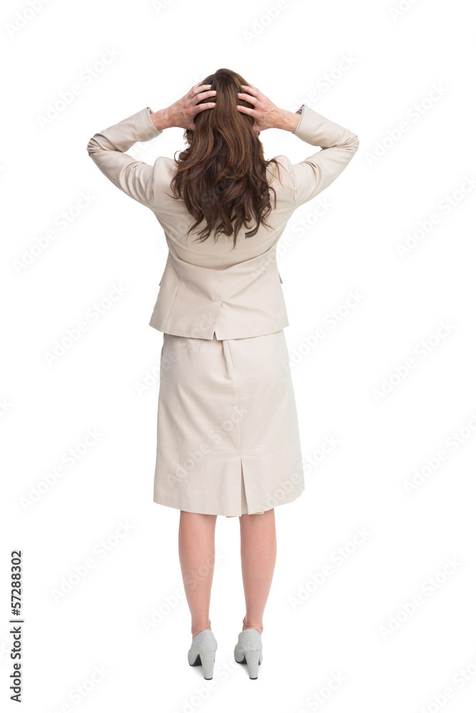 Businesswoman with hands on head standing back to camera Businesswoman with hands on head standing back to camera