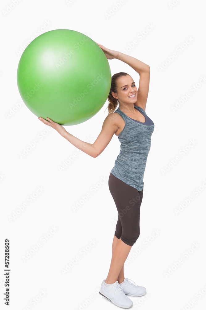 Cheerful blonde woman holding a fitness ball Cheerful blonde woman holding a fitness ball
