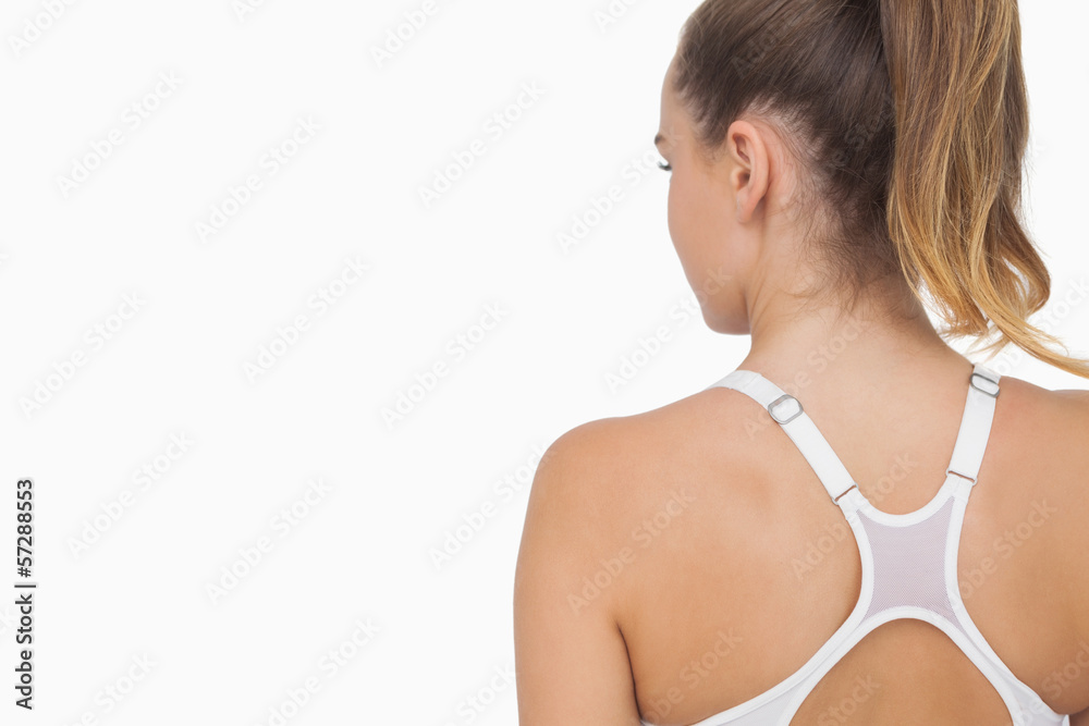 Rear view of ponytailed young woman wearing a sports bra Rear view of ponytailed young woman wearing a sports bra