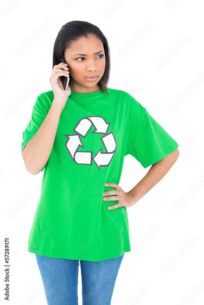 Unsmiling dark haired environmental activist making a phone call Unsmiling dark haired environmental activist making a phone call