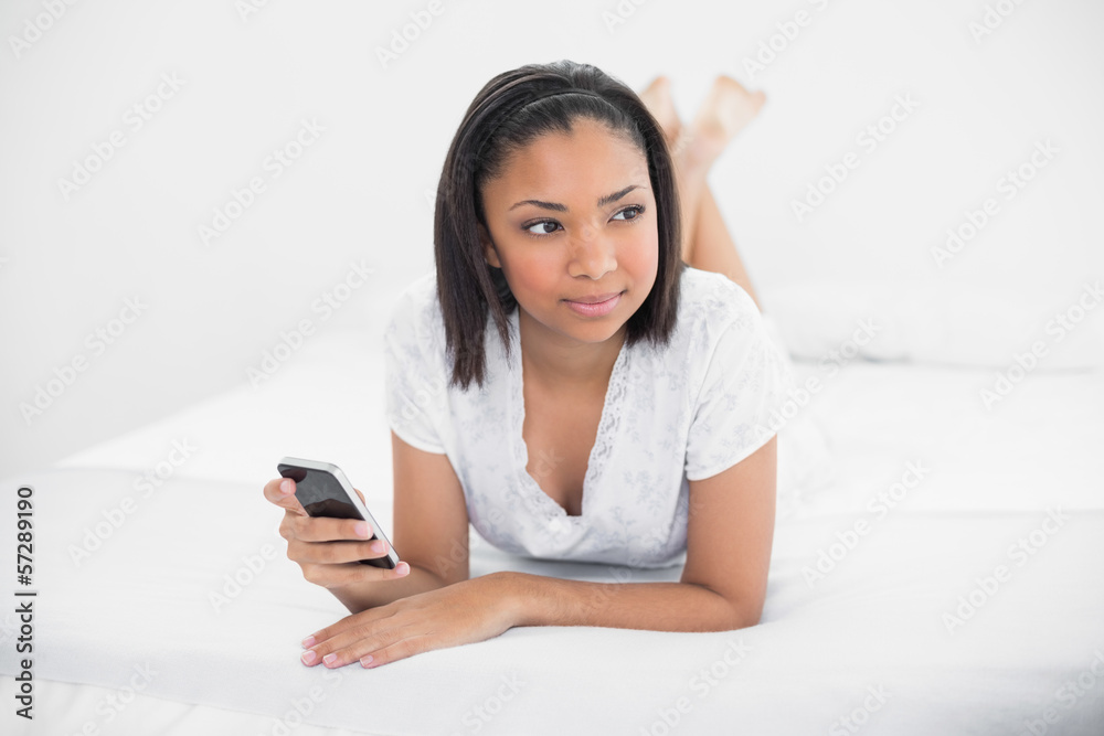 Attractive young dark haired model holding a mobile phone Attractive young dark haired model holding a mobile phone