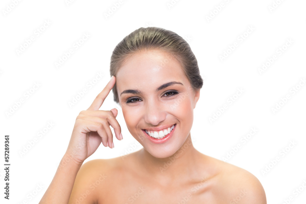 Laughing young woman touching her forehead