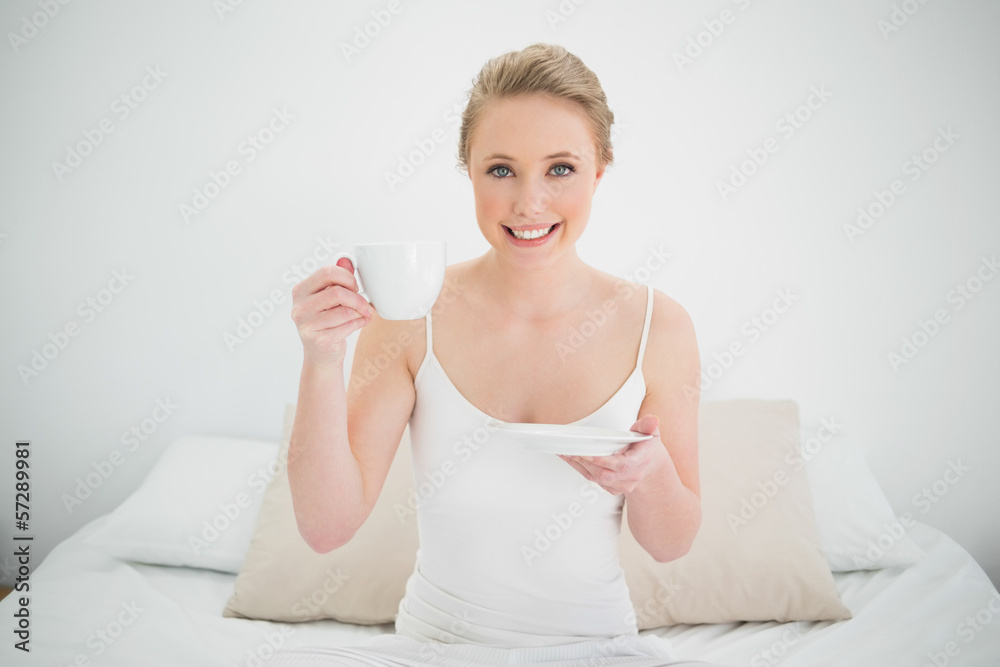 Natural happy blonde holding a cup Natural happy blonde holding a cup