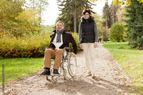 Woman next to man in wheelchair photo