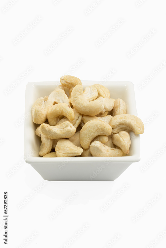 Isolated cashews in white dish on white background Isolated cashews in white dish on white background