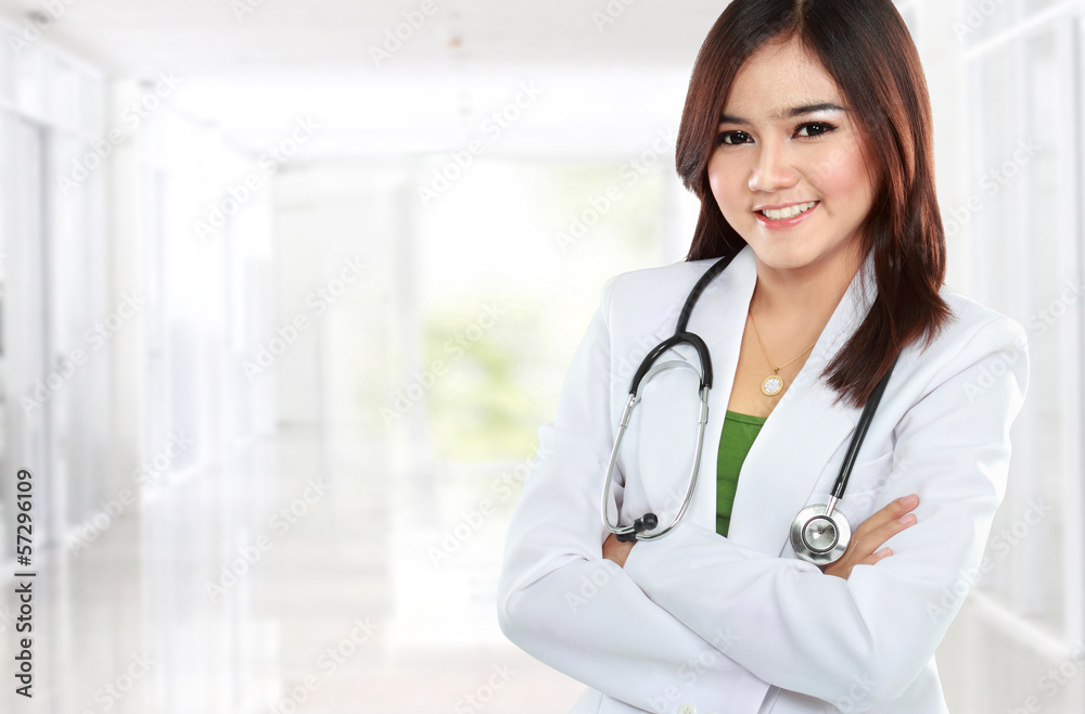 Smiling asian doctor wearing a white coat and stethoscope with a Smiling asian doctor wearing a white coat and stethoscope with a