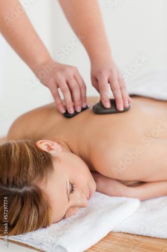 Therapist making a massage to an attractive blond-haired woman