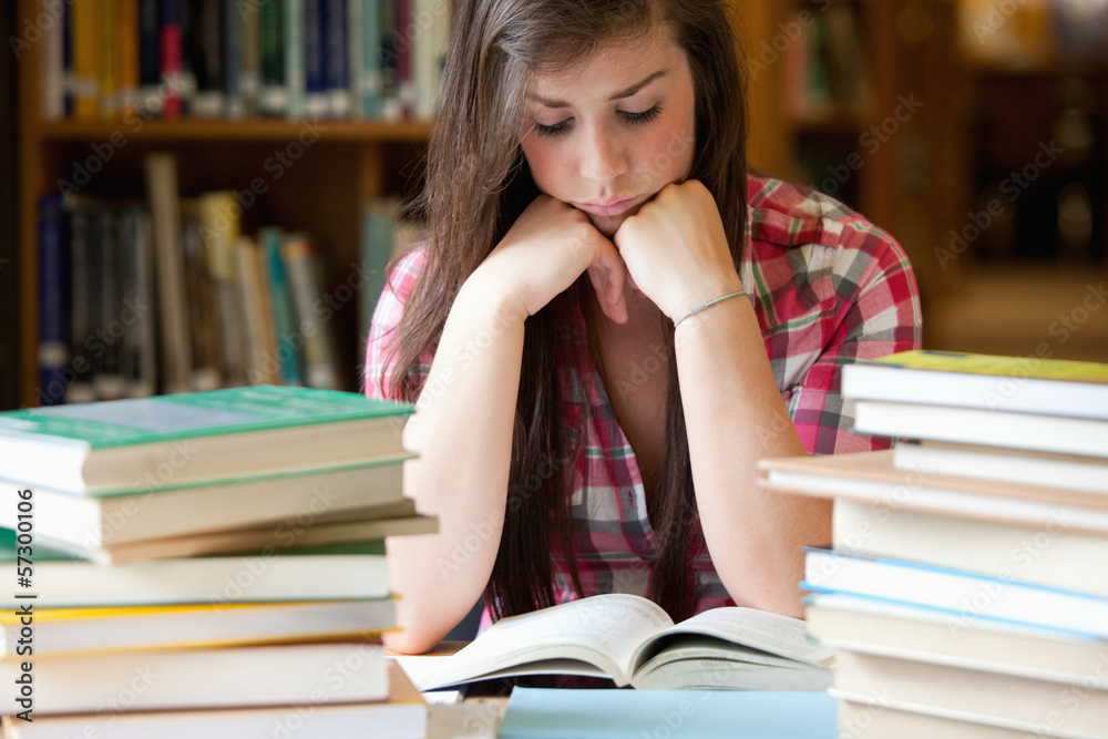 Studious woman surrounded by books Studious woman surrounded by books