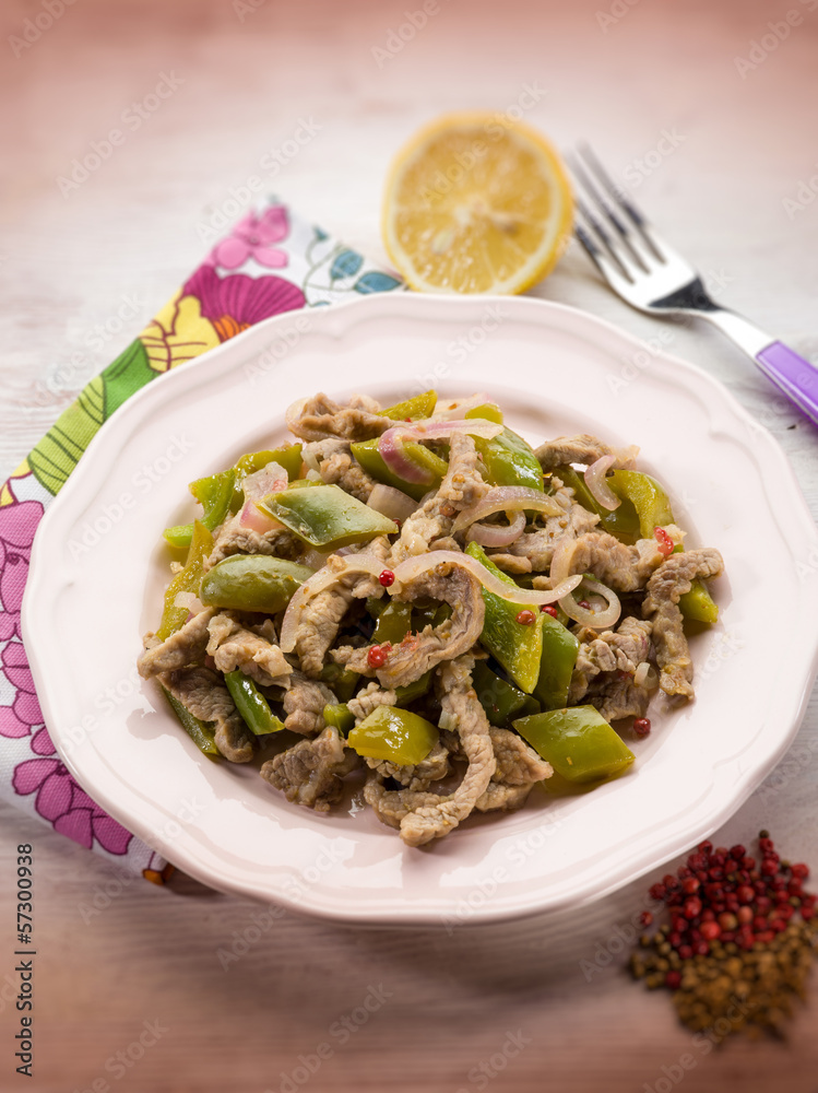 meat stew with capsicum red pepper and cilantro, selective focus