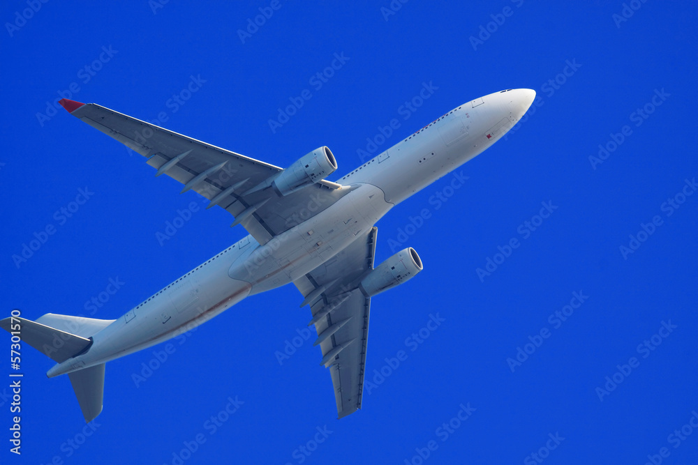 Passenger jet air plane flying on blue sky Passenger jet air plane flying on blue sky
