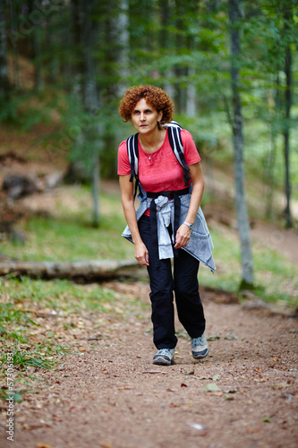 Female tourist hiking in a mountain forest