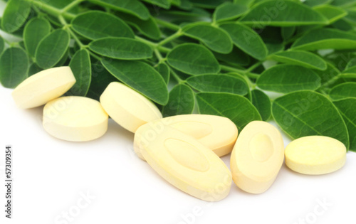 Edible moringa leaves with pills photo