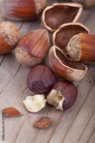 .hazelnuts with its shell on a wooden table