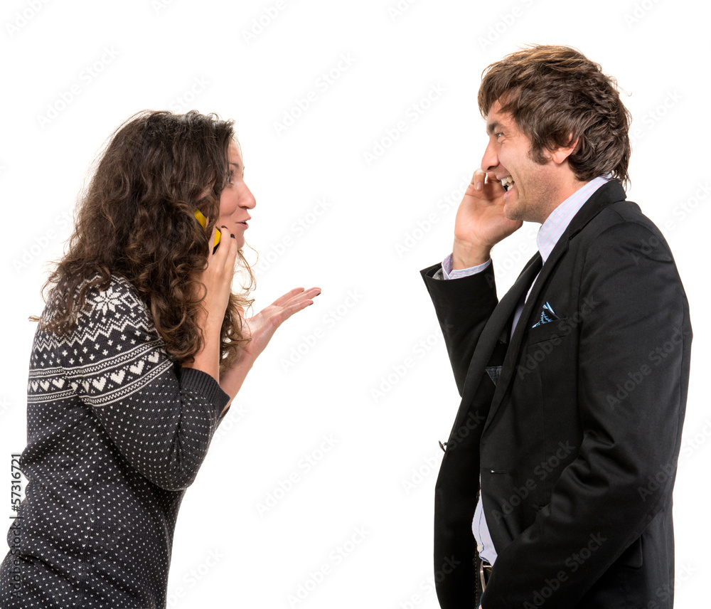 Smiling man and woman with cell phones Smiling man and woman with cell phones