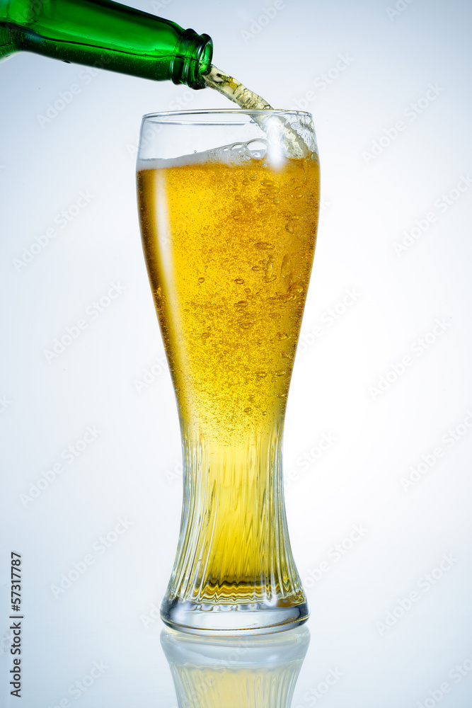 Beer is pouring from bottle into the glass Beer is pouring from bottle into the glass