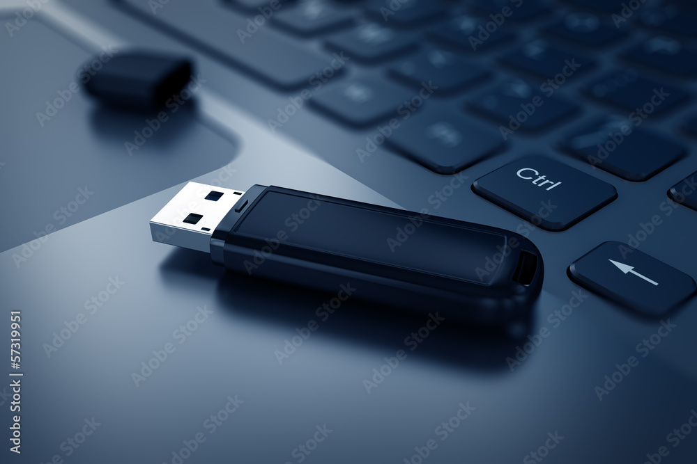 Modern USB Flash drive on laptop keyboard - obrazy, fototapety, plakaty 
