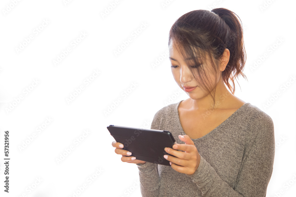 Asian young woman using iPad tablet pc ebook