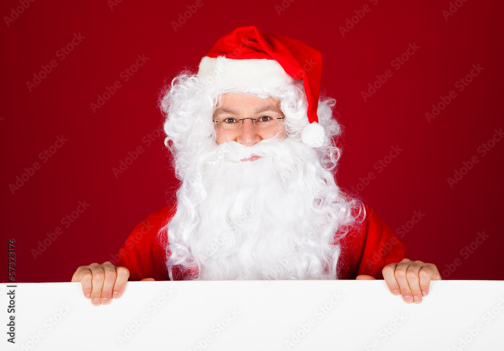 Portrait of a santa holding blank placard