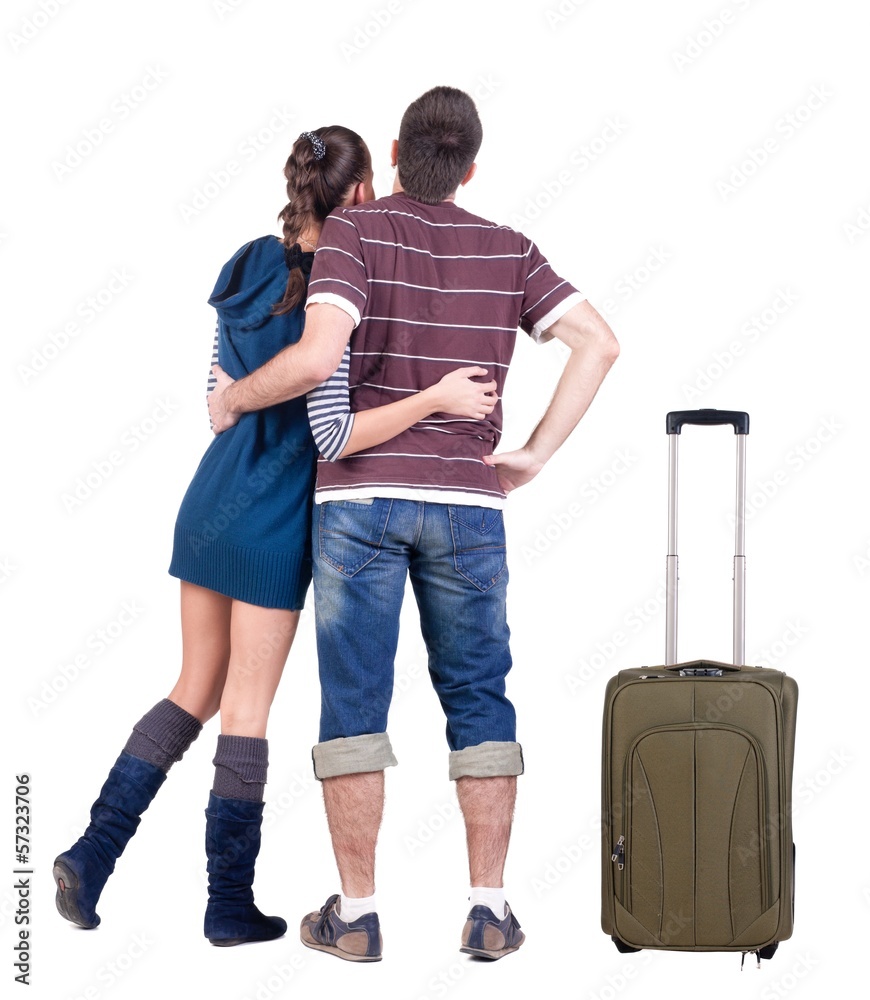 Young traveling couple with suitcas looks where that. Young traveling couple with suitcas looks where that.