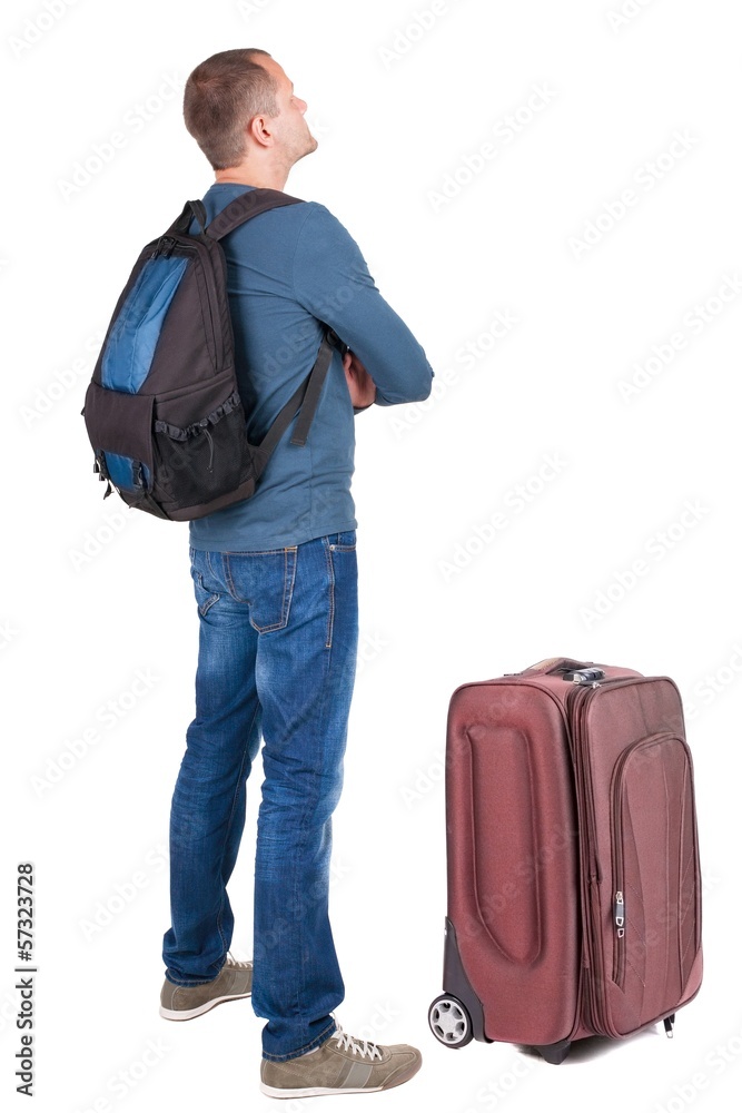 Back view of man with photographic backpack looking up Back view of man with photographic backpack looking up