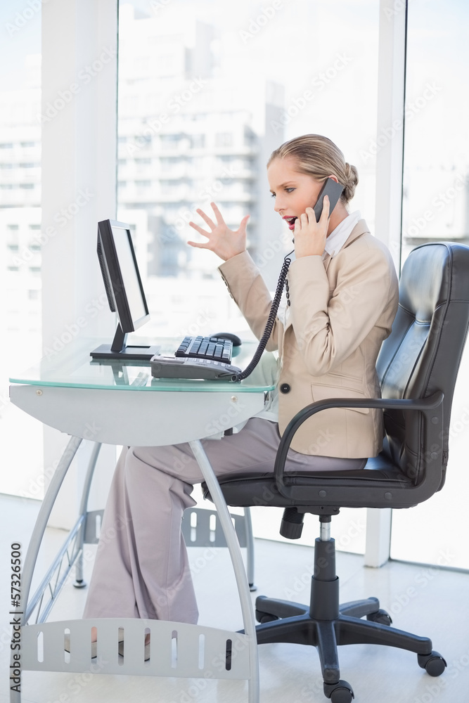 Angry blonde businesswoman on the phone Angry blonde businesswoman on the phone