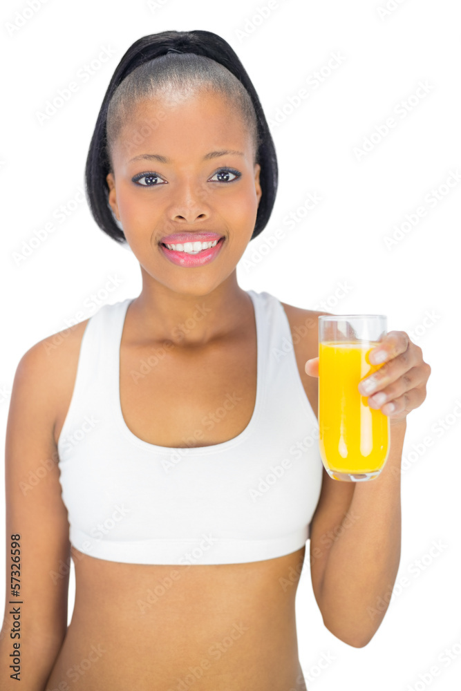 Fit smiling woman holding glass of orange juice Fit smiling woman holding glass of orange juice