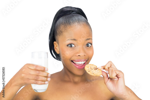 Attractive woman drinking milk and holding biscuit