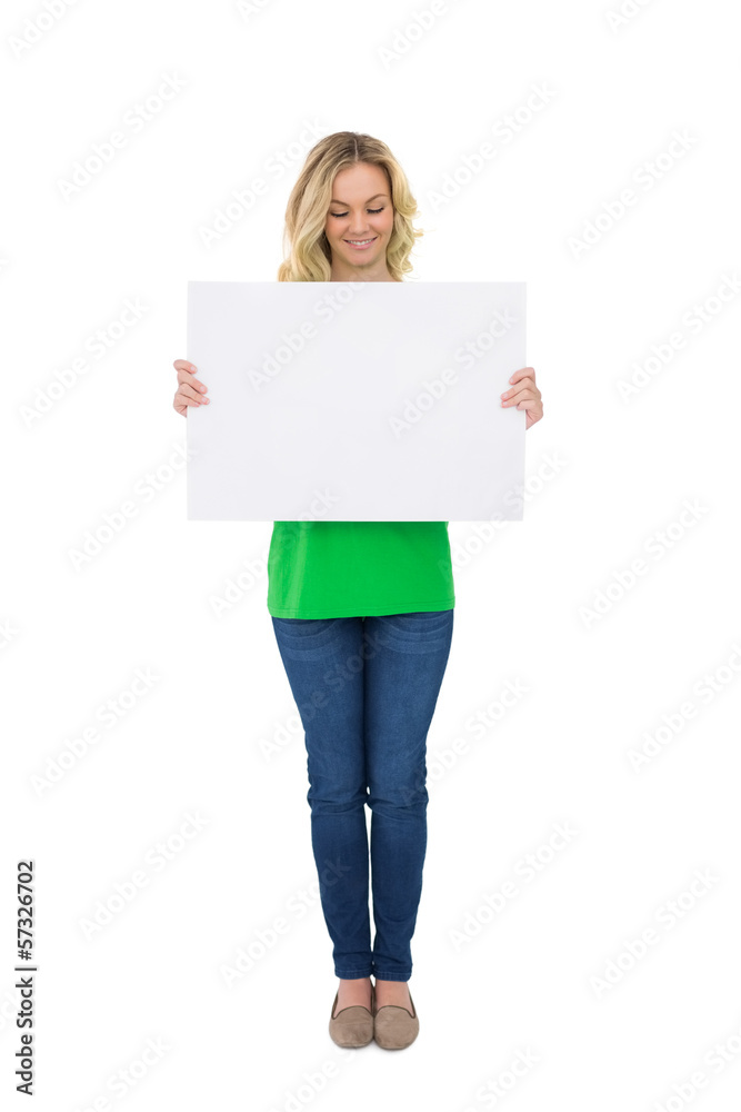 Smiling cute blonde holding white poster Smiling cute blonde holding white poster