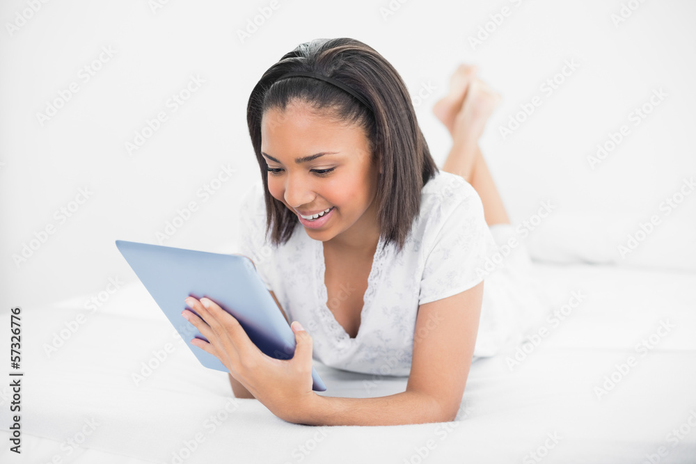 Stylish young dark haired model using a tablet pc Stylish young dark haired model using a tablet pc