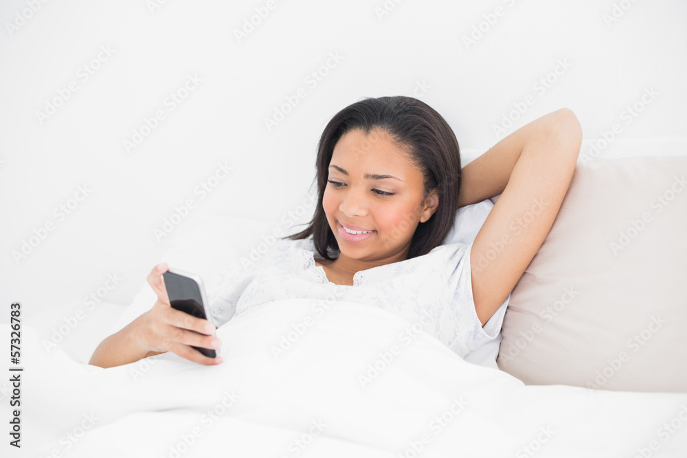 Calm young dark haired model holding a mobile phone Calm young dark haired model holding a mobile phone
