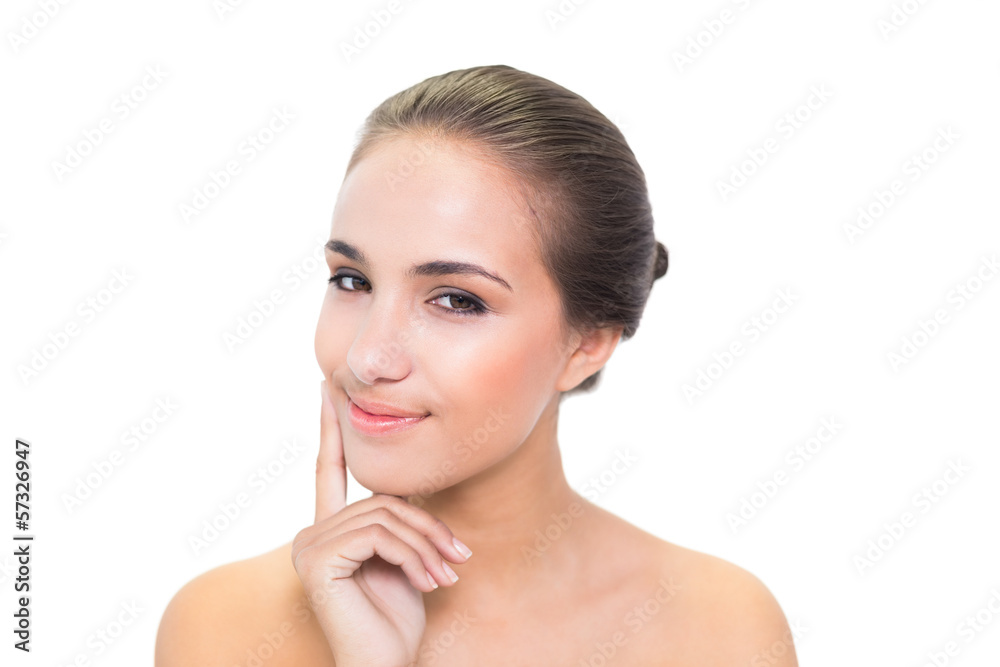 Thoughtful smiling brunette woman looking at camera