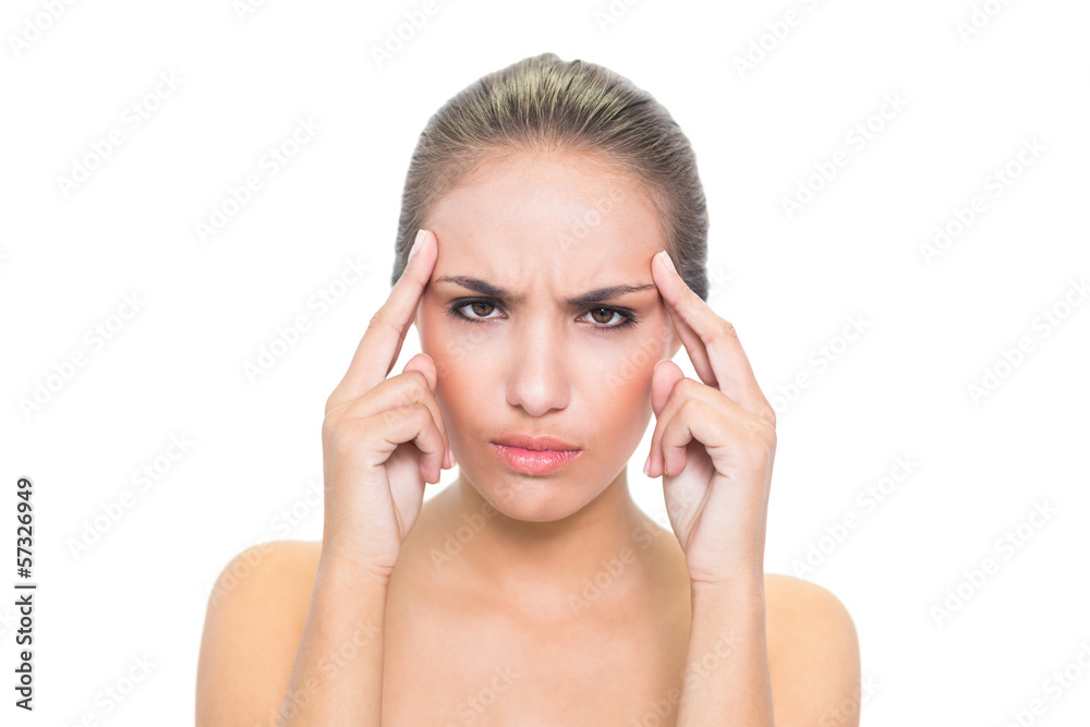 Angry young brunette woman touching her temples Angry young brunette woman touching her temples