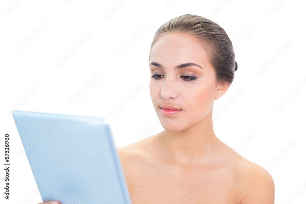 Content brunette woman holding a tablet Content brunette woman holding a tablet