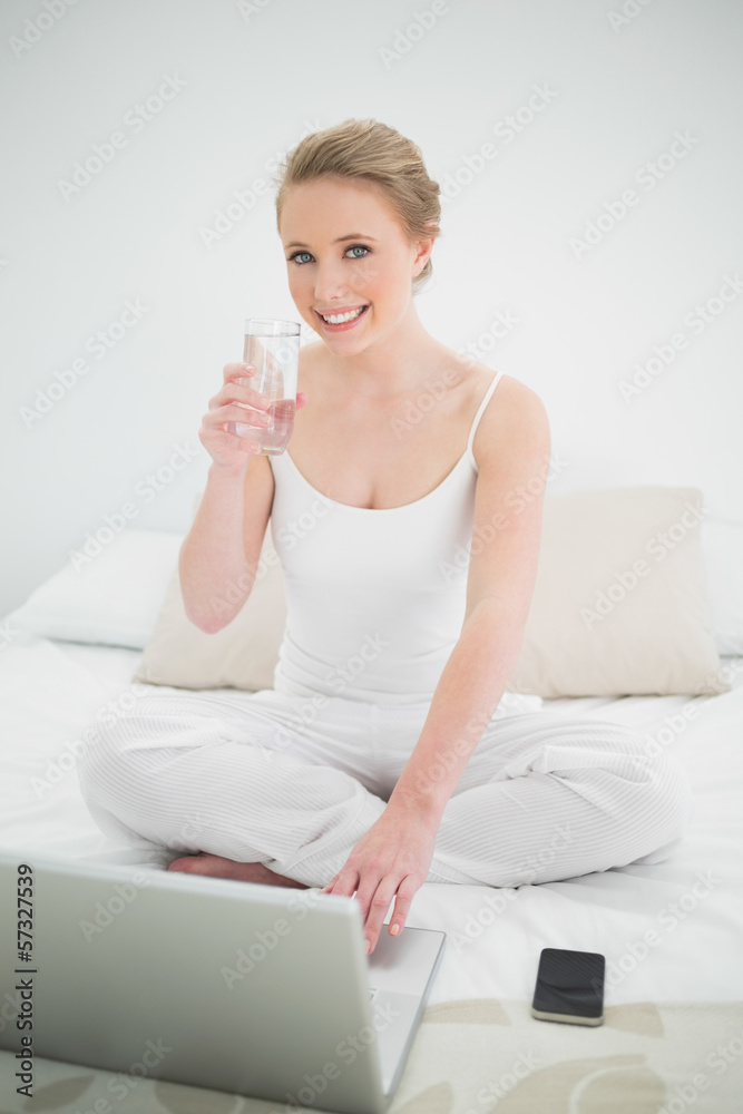 Natural cheerful blonde holding glass of water Natural cheerful blonde holding glass of water