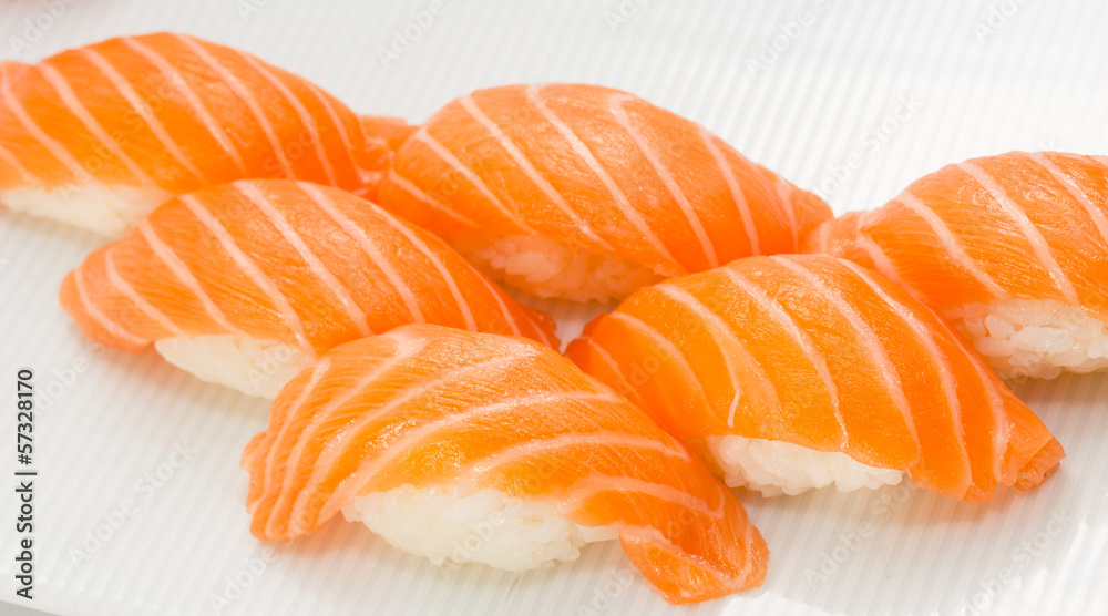 Salmon sushi nigiri on white plate and background with wasabi