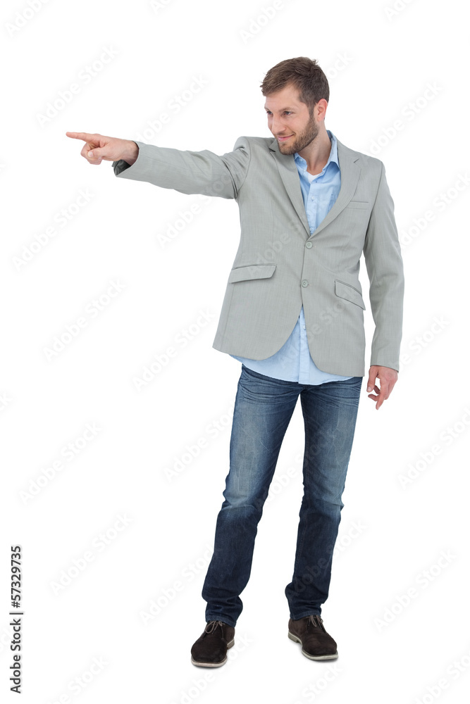 Smiling trendy model pointing to something Smiling trendy model pointing to something