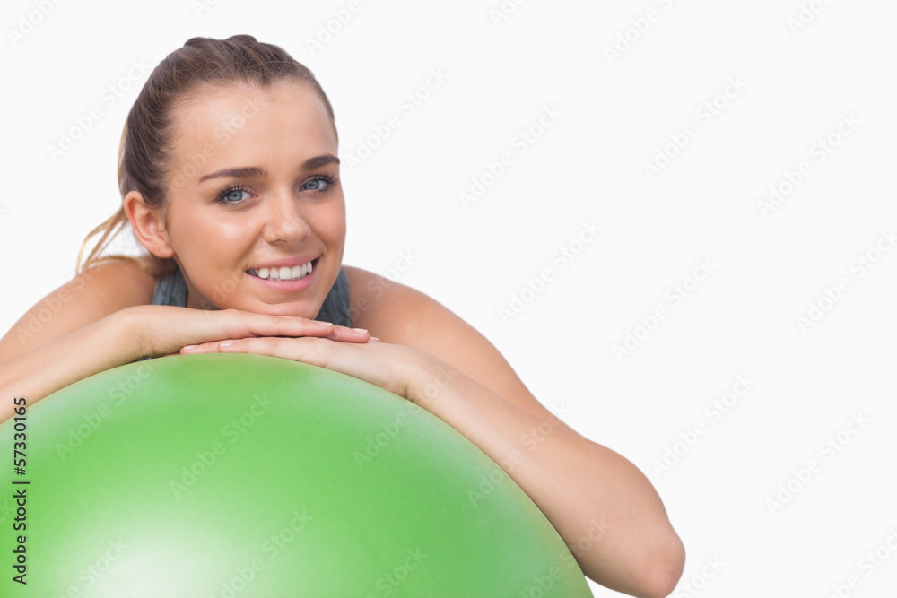 Sporty attractive woman supporting herself with a fitness ball Sporty attractive woman supporting herself with a fitness ball