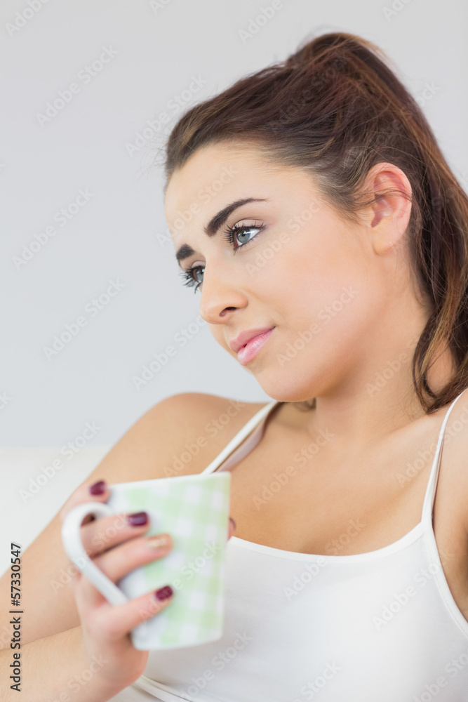 Handsome woman day dreaming sitting on a couch Handsome woman day dreaming sitting on a couch