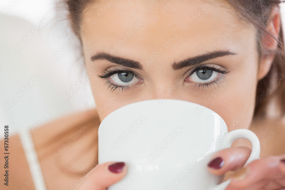 Close up of a cute brunette woman drinking coffee Close up of a cute brunette woman drinking coffee