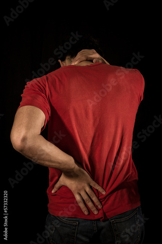 Young man with neck and back pain