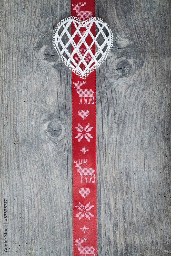 Fototapeta premium Red christmas ribbon on old wooden backround