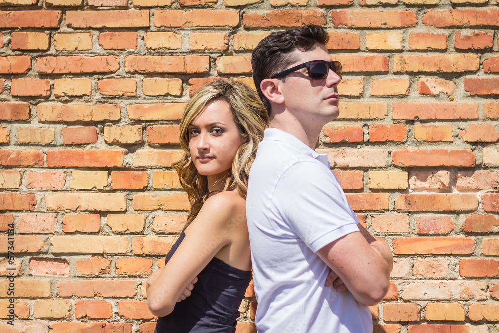 Couple portrait in front of brick wall