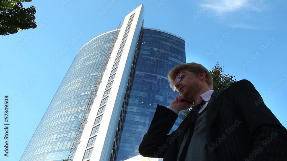 Stock broker businessman talks business phone, office building Stock broker businessman talks business phone, office building
