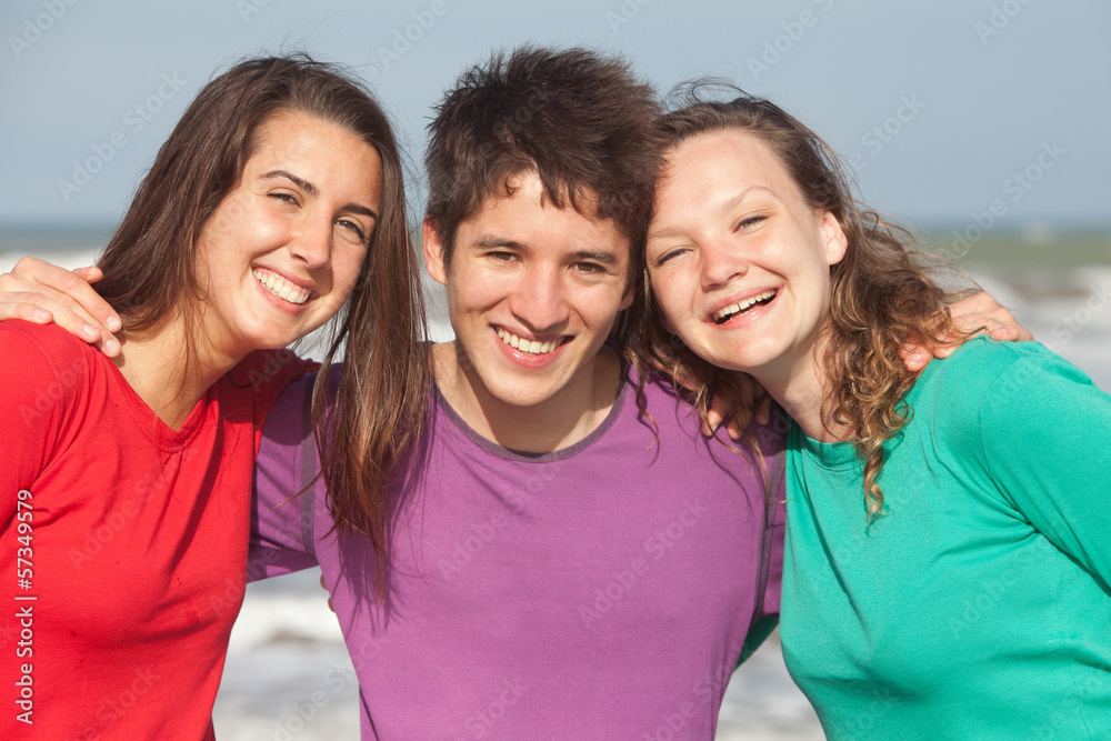 group of happy youth in colorful clothes at the beach group of happy youth in colorful clothes at the beach